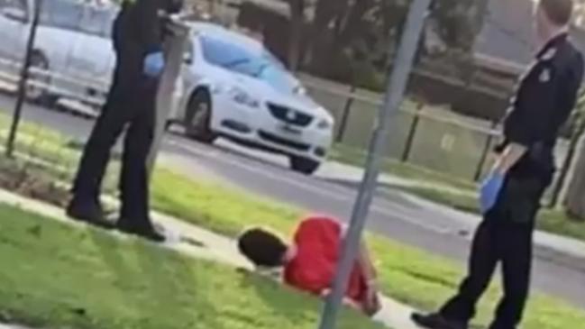 Video shows a man handcuffed on the ground. Picture: Nine News