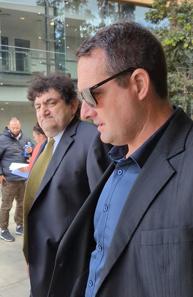 Julian Mark Jonic (wearing black suit and sunglasses) leaves Ipswich Court on October 4, 2023, with his lawyers. Picture: Nicola McNamara