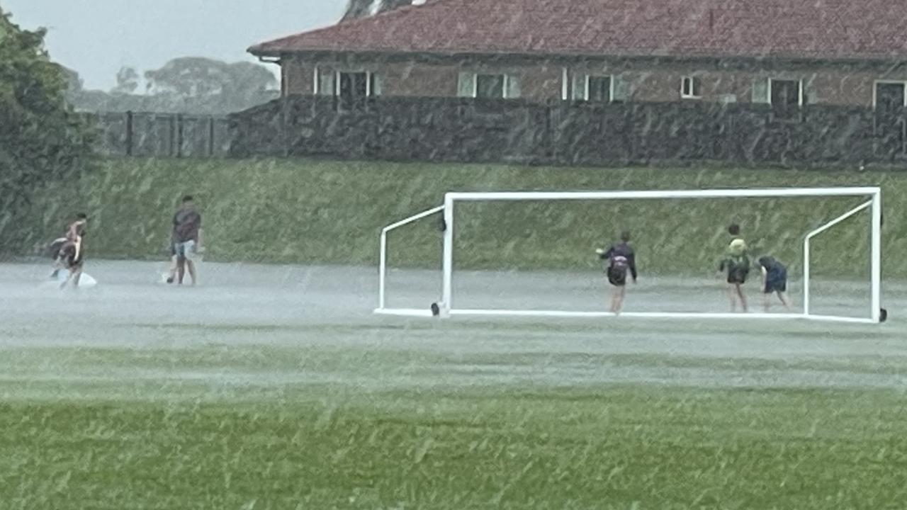 Torrential downpour transforms footy field into water park