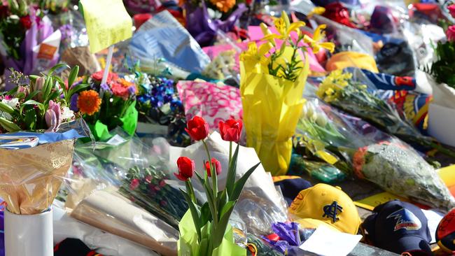 Fans laid thousands of flowers and wreaths at Crows headquarters to honour late coach Phil Walsh. Pic: Tricia Watkinson