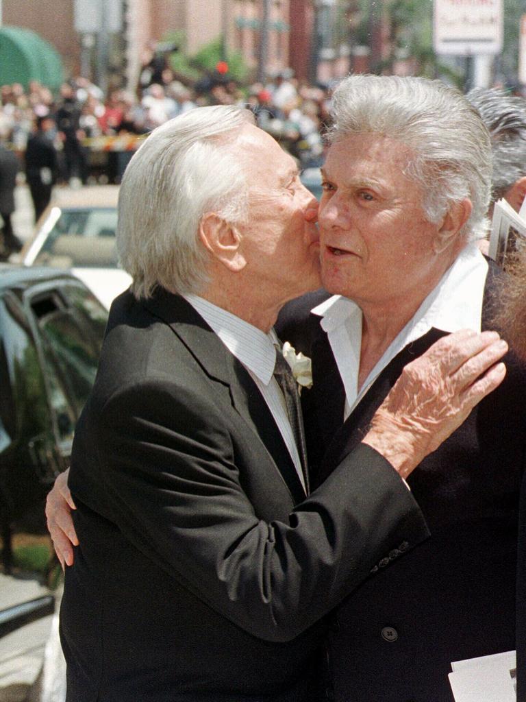 Douglas, left, with actor Tony Curtis following the funeral of actor and singer Frank Sinatra in Beverly Hills, California, 1998.