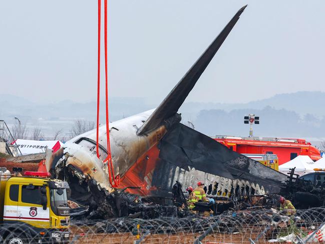 Recovery teams work at the scene where a Jeju Air Boeing 737-800 series aircraft crashed and burst into flames at Muan International Airport in Muan. Picture: AFP