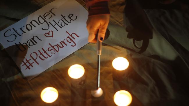 People light candles in Tel Aviv, Israel, in a commemoration of the victims of the deadly shooting. Picture: AP