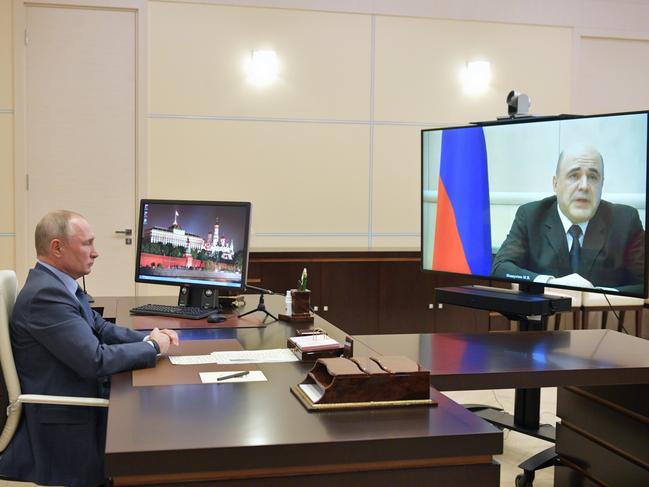 Russian President Vladimir Putin listens to Russian Prime Minister Mikhail Mishustin, who has tested positive for the coronavirus. Picture: AP