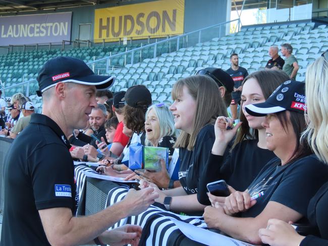 Collingwood coach Craig McRae signs autographs for fans. Picture: Jon Tuxworth