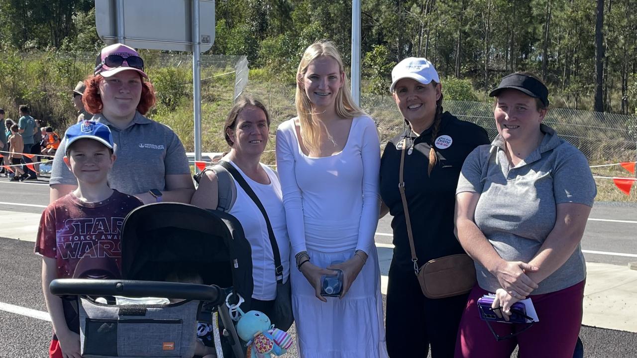 Riley Franz, Torri Franz, Shanna Lieschke, Tori Mason, Shellie Johns, Jessika Franz, and Arlo Bond celebrate the impending opening of the Gympie Bypass at a community event on Saturday August 17, 2024.