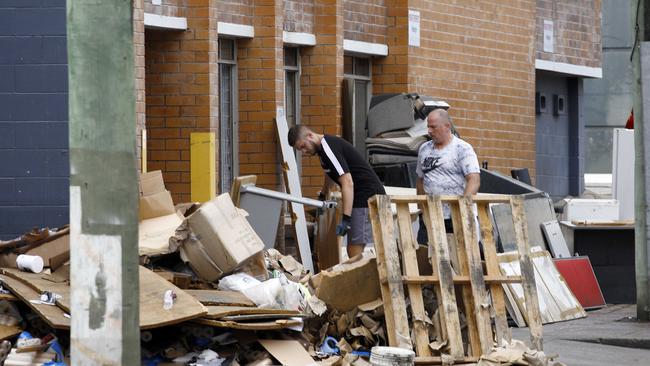 A man cleaning up outside a business in Milton. Picture: Tertius Pickard