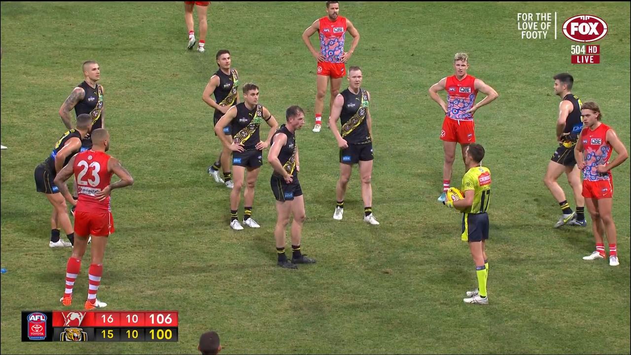 Richmond players remonstrate with the umpire as he makes the call to not award the 50m penalty. Picture: Fox Footy