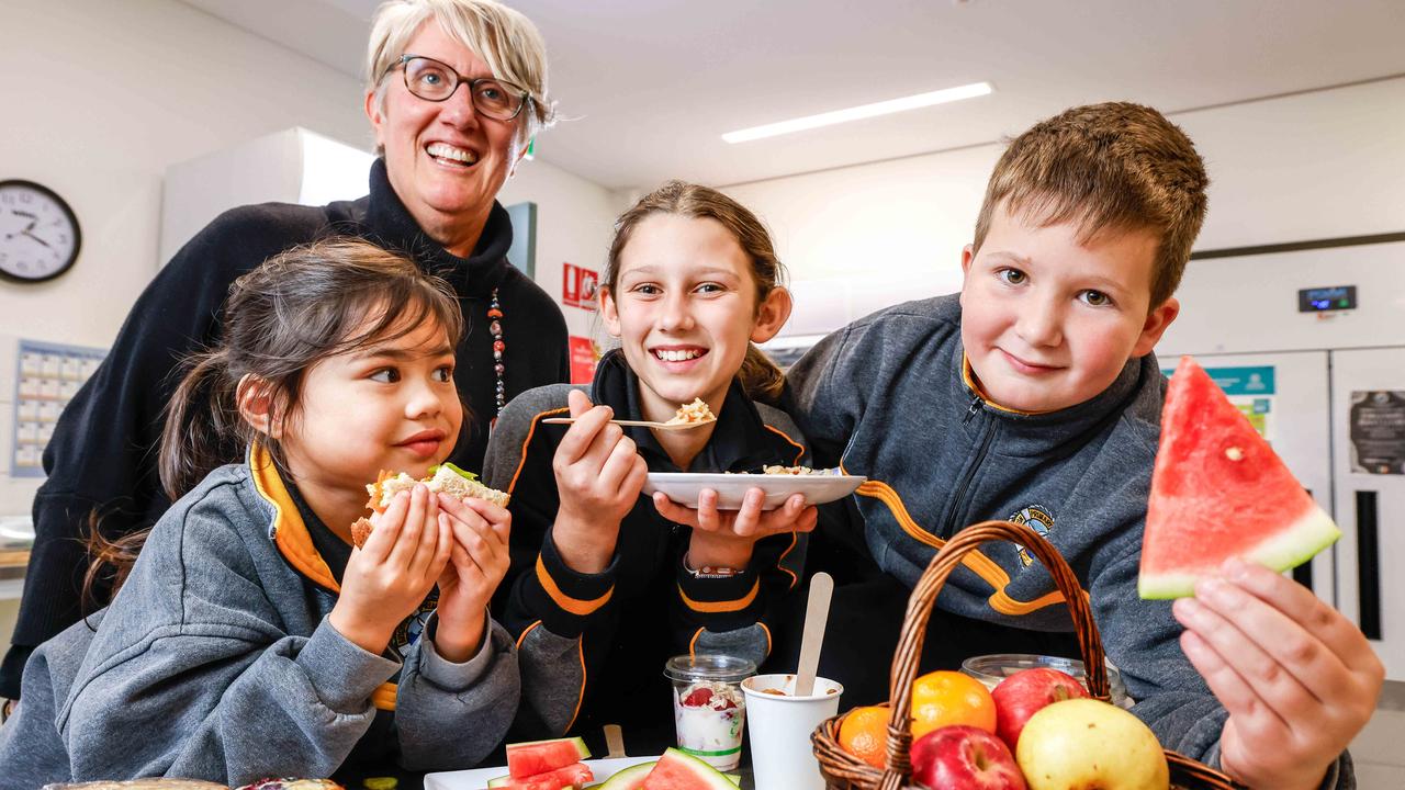 Food for thought: Brighton Primary School students Mila, 5, Maddie, 11, and Carter, 9, enjoy some of the healthy eating options in the school’s canteen with principal Rebecca Read. Picure: Russell Millard