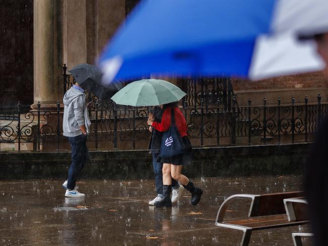 SYDNEY, AUSTRALIA - NewsWire Photos, May 2, 2025. Wet weather. Pedestrians huddle under umbrellas as rain continues to drench the city. Picture: NewsWire / Max Mason-Hubers
