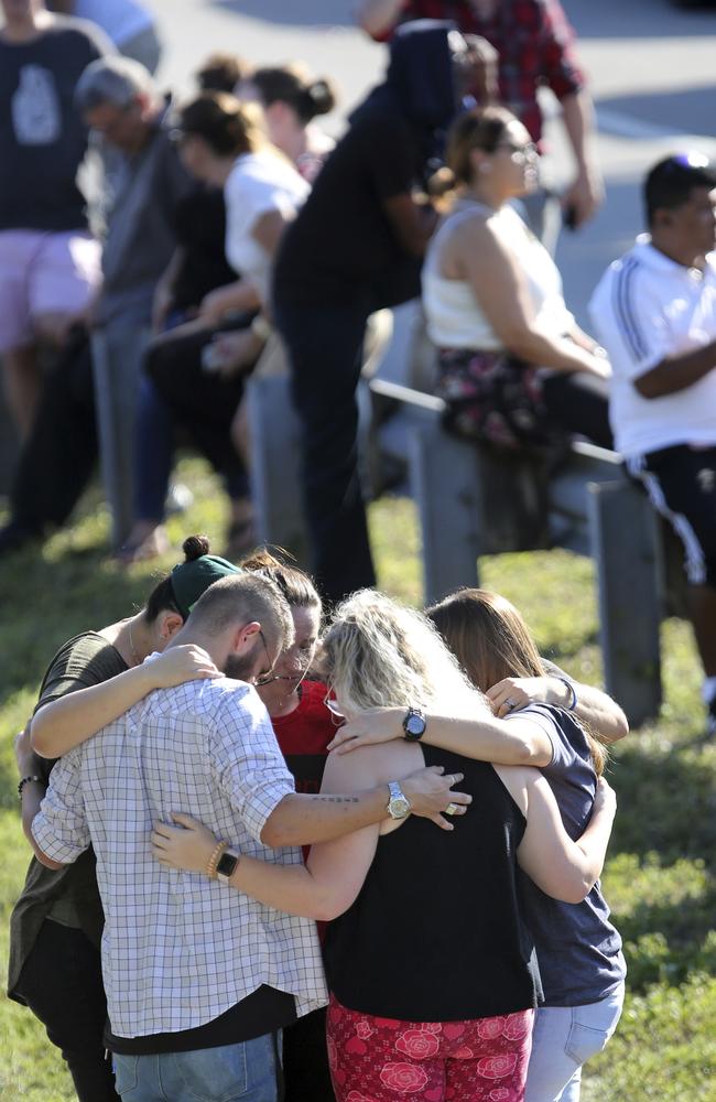 People gather waiting for word from students outside Marjory Stoneman Douglas High School. Picture: AP