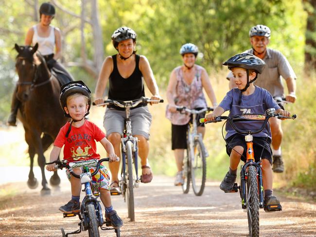 Owen, 4, Simone and Ethan, 6, lead Lauren Howes, 22, on Remi, and Diane and Mal Poulton on the Lilydale to Warburton Rail Trail, one of Victoria's many disused rail trails that have been turned into bicycle, walking and horseriding paths.