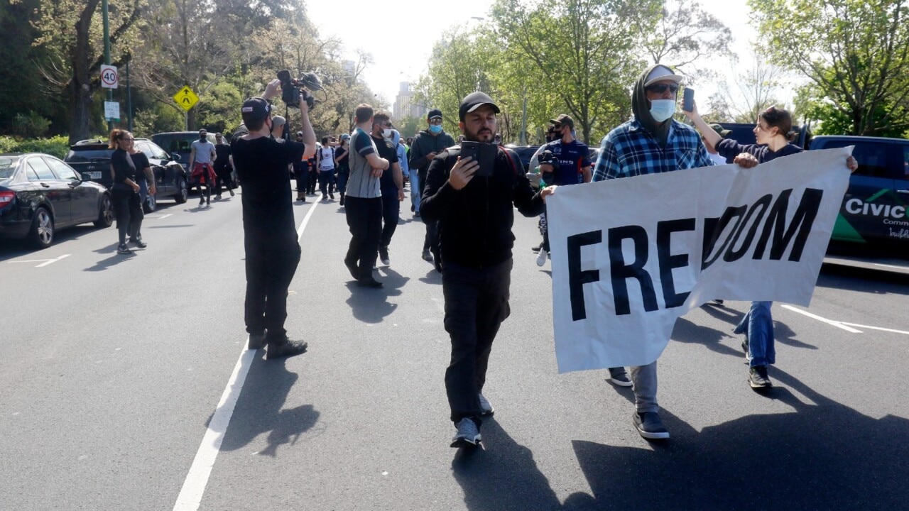 Protesters march in Melbourne against mandatory vaccines