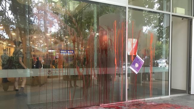 Red paint was hurled at campus buildings by protesters.