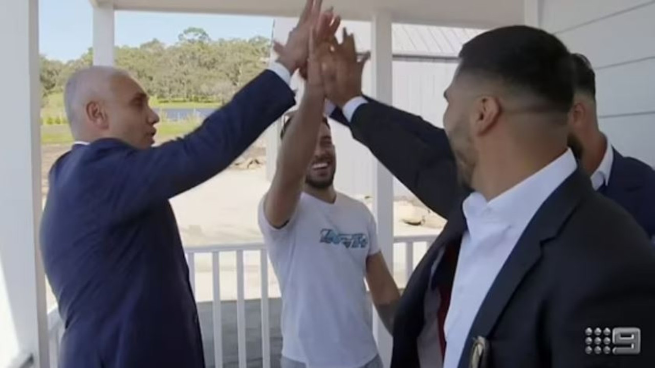 Bidder Adrian Portelli high-fives Omar, Oz and their real estate agent. Picture: Nine