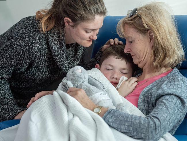 Jayden Ryan, 7, is looked after by his mother Kylie Zahra and grandmother Fawna Lennon post op. Picture: Jake Nowakowski