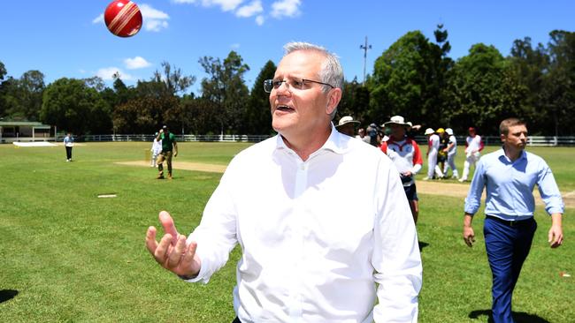 Australian Prime Minister Scott Morrison flicks a cricket ball after bowling at the Brookfield Showgrounds in Brisbane. Picture: NCA NewsWire / Dan Peled.