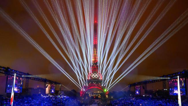 Overview of the Trocadero venue, with the Eiffel Tower looming in the background  and lasers lighting up the sky, during the opening ceremony of the Paris 2024 Olympic Games on July 26, 2024 (Photo by FranÃ§ois-Xavier MARIT / AFP)