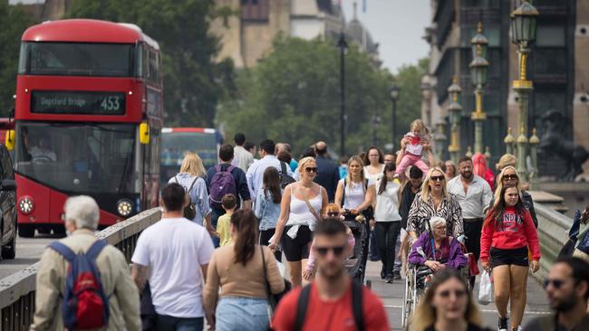 Pedestrians cross on Westminster Bridge.