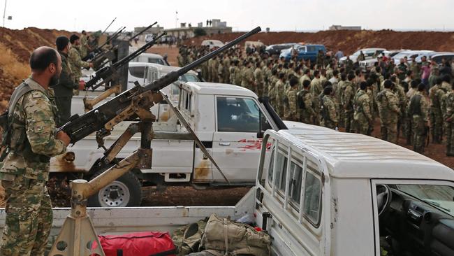 Turkish-backed Syrian rebel fighters gather near the Syrian-Turkish border north of Aleppo. Picture: AFP.