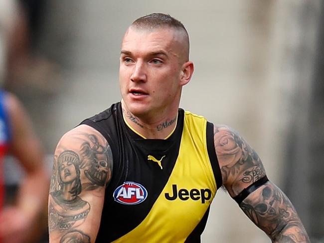 MELBOURNE, AUSTRALIA - AUGUST 25: Dustin Martin of the Tigers fends off Alex Witherden of the Lions during the 2019 AFL round 23 match between the Richmond Tigers and the Brisbane Lions at the Melbourne Cricket Ground on August 25, 2019 in Melbourne, Australia. (Photo by Michael Willson/AFL Photos via Getty Images)