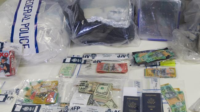 Drugs, passports and money at a police press conference about the bust. Picture: AAP Image/Erik Anderson