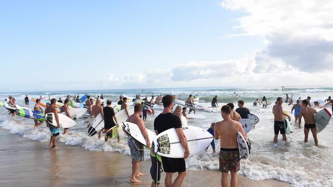 Chris Hemsworth joined locals to honour the memory of Currumbin Vikings Surf Club president John Munro at Currumbin Beach on Saturday.