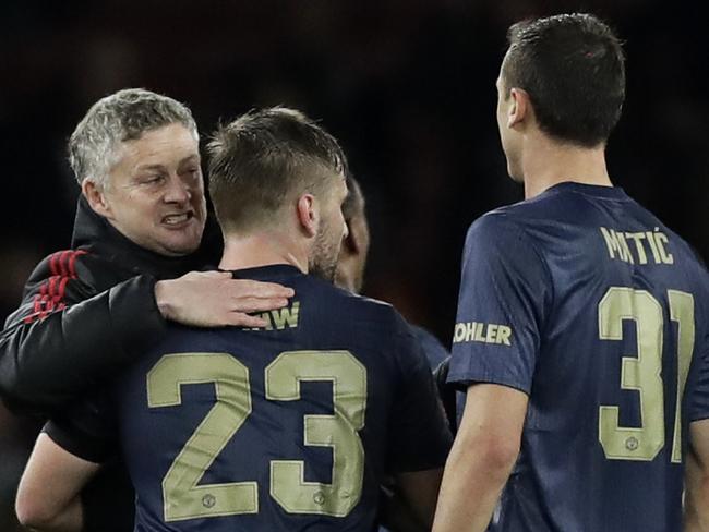 Manchester United caretaker head coach Ole Gunnar Solskjaer, left, celebrates with his players at the end of the English FA Cup fourth round soccer match between Arsenal and Manchester United at the Emirates stadium in London, Friday, Jan. 25, 2019. (AP Photo/Matt Dunham)