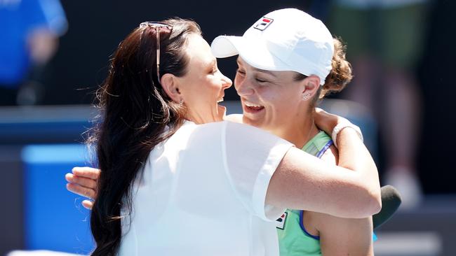 Ash Barty (R) hugs great mate Casey Dellacqua after the win. Picture: AAP/Dave Hunt