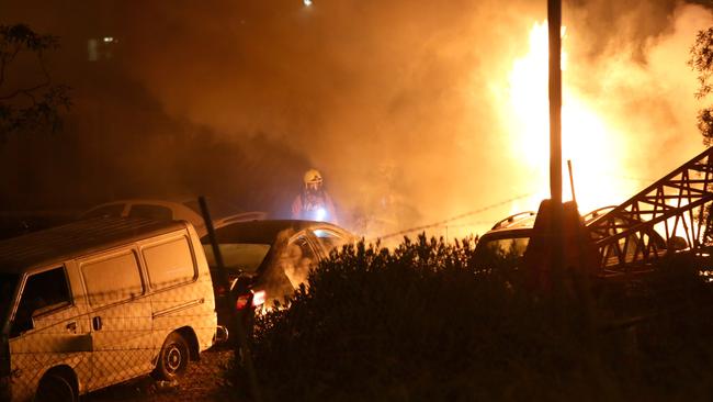 Fire has burnt out a car wrecking yard on Camden Valley Way, Smeaton Grange. Picture: Bill Hearne