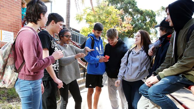 Year 10 students from Warrakirri College enjoy a lunch break and light up some cigarettes in the "smoking zone" at the front of the school. Picture: Sam Ruttyn