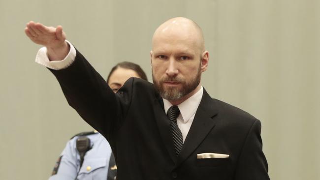 Anders Behring Breivik raises his right hand in court. Picture: Lise Aaserud/NTB Scanpix