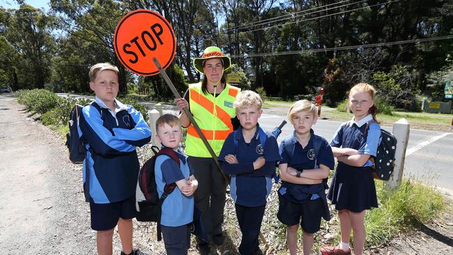 Doris Mullis and Kinglake West Primary students Aiden, Oliver, Carl, Josh and Evelyn want a safe passageway to and from their school. Picture: George Salpigtidis