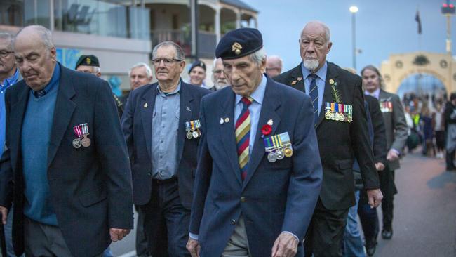 John Ellis lead and John Price lead a group of veterans at the 2022 Anzac Day Dawn Service march, at the Memorial Arch in Brighton. Picture Emma Brasier