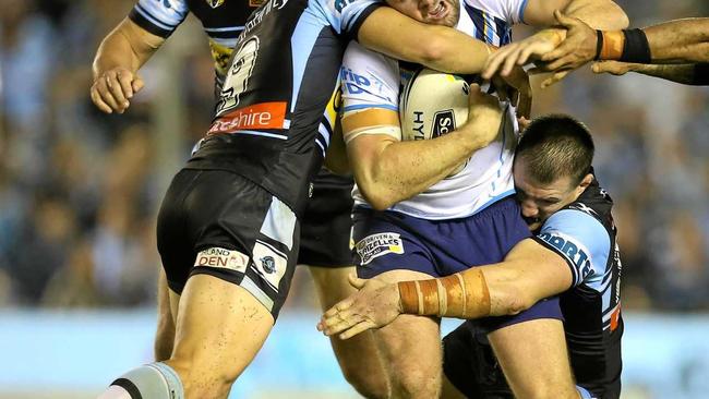 Anthony Don of the Titans tackled by Jayden Brailey and Paul Gallen of the Sharks during the Round 8 NRL match between the Cronulla-Sutherland Sharks and the Gold Coast Titans at Southern Cross Group Stadium in Sydney, Saturday, April 22, 2017. (AAP Image/Craig Golding) NO ARCHIVING, EDITORIAL USE ONLY. Picture: CRAIG GOLDING/AAP