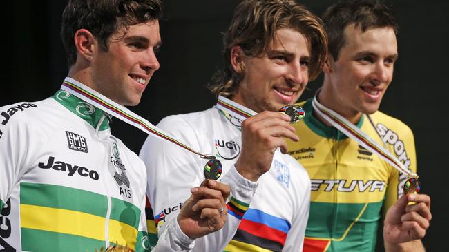 Peter Sagan, center, of Slovakia, winner of the UCI men's road world championship cycling race, celebrates with second-place Michael Matthews, left, of Australia, and third-place Ramunas Navardauskas, of Lithuania, in Richmond, Va., Sunday, Sept. 27, 2015. (AP Photo/Steve Helber)