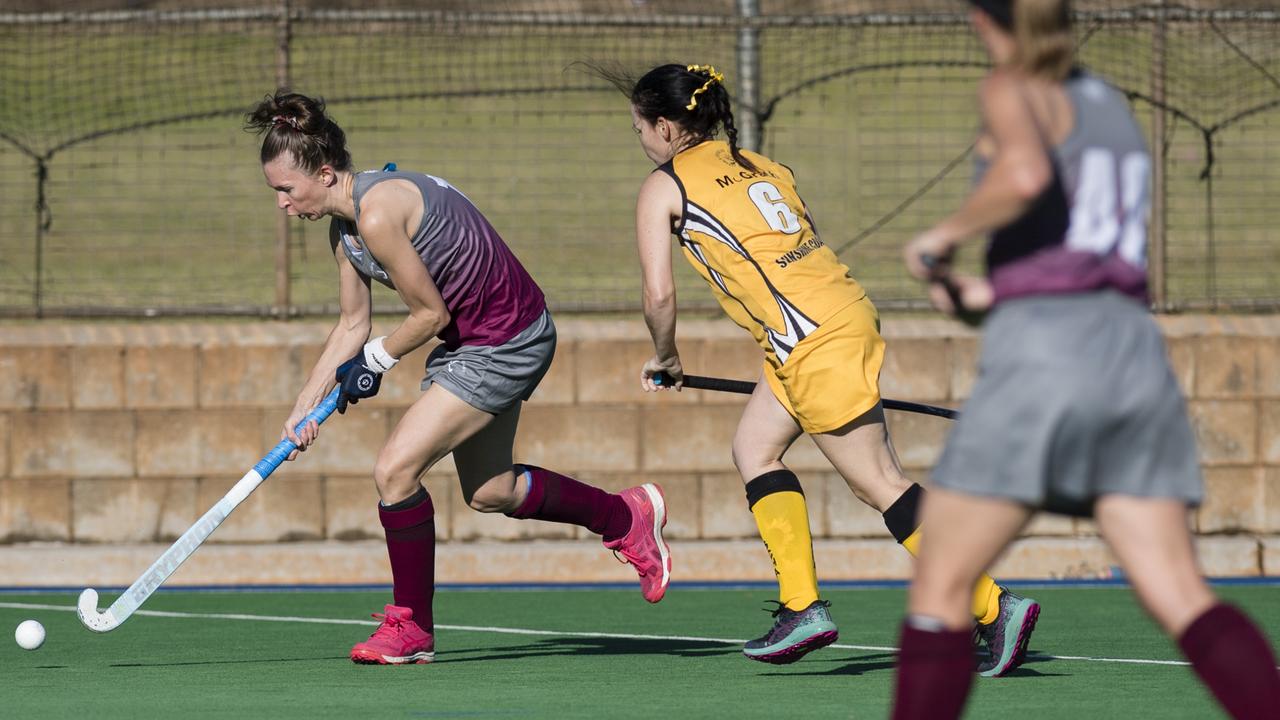 Kate Evans (left) of Gladstone 1 against Sunshine Coast 2.