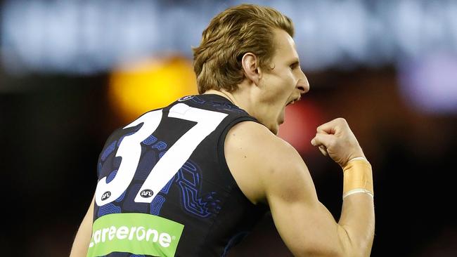 Daniel Gorringe celebrates after kicking a goal for Carlton.