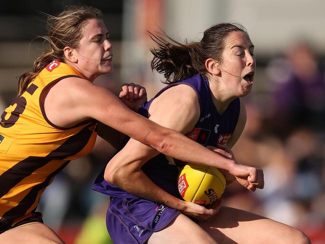 Aide Tighe of the Dockers marks the ball against Emily Everist (left) of the Hawks during round three AFLW match between Fremantle Dockers and Hawthorn on September 16, 2023, in Perth, Australia. Picture: Paul Kane.