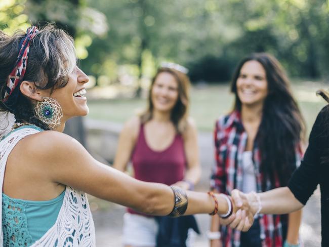 Girls shaking hands in the park