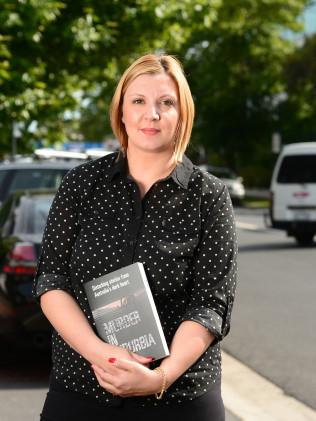 Author Emily Webb with her book on suburban murders. Picture: Lawrence Pinder