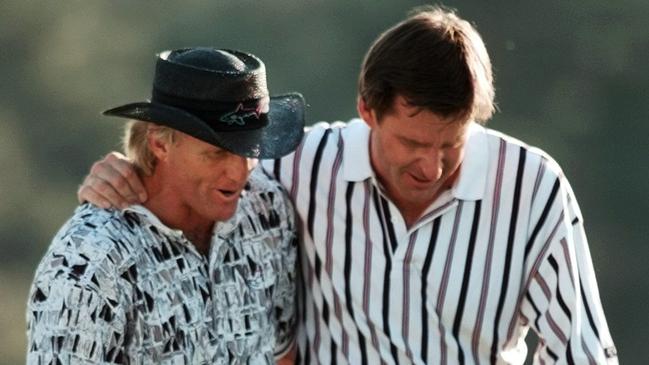 Norman (L) walks off the 18th green with England’s Nick Faldo after his famous collapse in 1996. Picture: AP