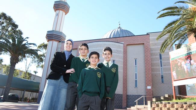 Local mother Fariha Dib with children L-R Jamal Kak, Zakariya Kak and Jibril Kak outside of Malek Fahd Islamic School in 2017.