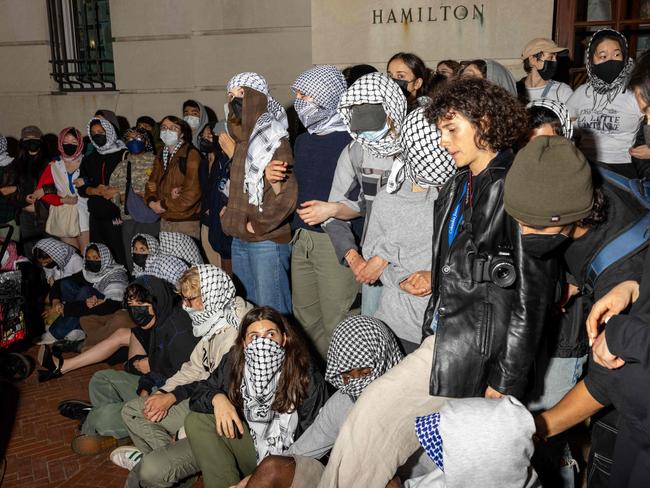 Students lock arms to prevent authorities reaching fellow protesters barricaded inside Hamilton Hall, where the office of the Dean is located. Picture: Getty Images via AFP