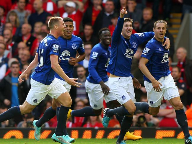 Phil Jagielka is swamped by his teammates after his last-minute heroics.