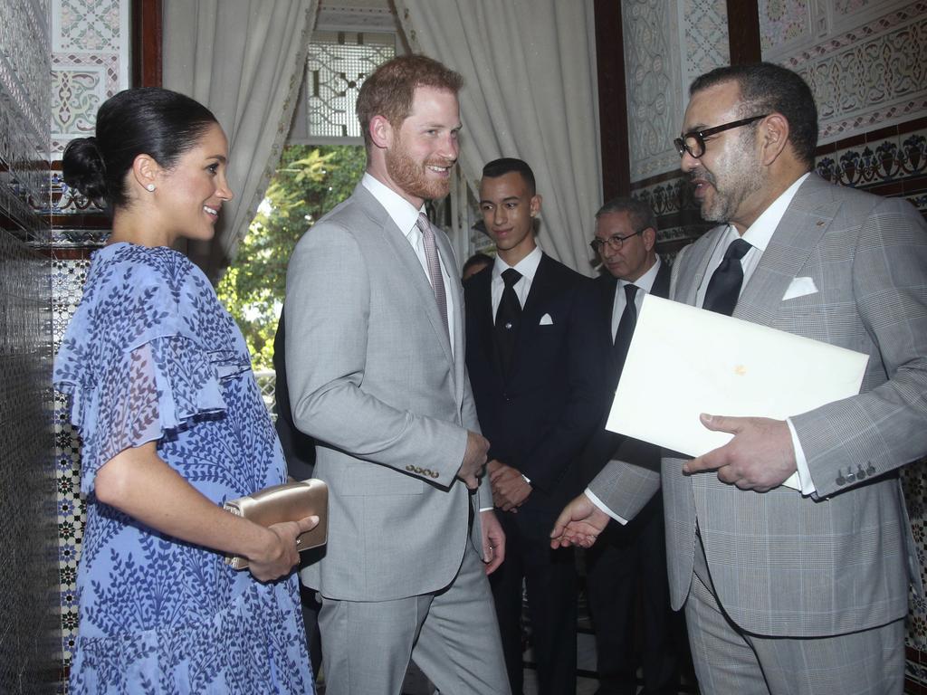 Britain's Prince Harry, centre and Meghan, the Duchess of Sussex, meet King Mohammed VI of Morocco.