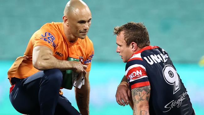 SYDNEY, AUSTRALIA - AUGUST 28:  Jake Friend of the Roosters is attended to by a trainer after a tackle during the round 16 NRL match between the Sydney Roosters and the Brisbane Broncos at the Sydney Cricket Ground on August 28, 2020 in Sydney, Australia. (Photo by Cameron Spencer/Getty Images)