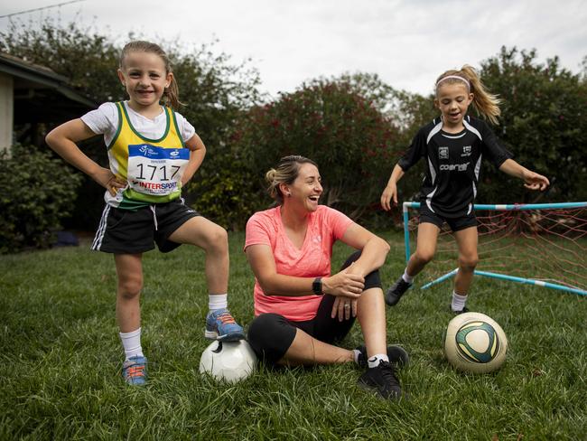 Heather Garriock with her daughters Kaizen, 7, (in black)  and Noa, 5 (in green and white) at their home in Canberra. Picture by Sean Davey.