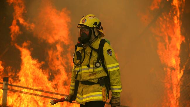 A firefighter prepares to battle one of dozens of blazes on the NSW mid-north coast. Picture: Jane Dempster