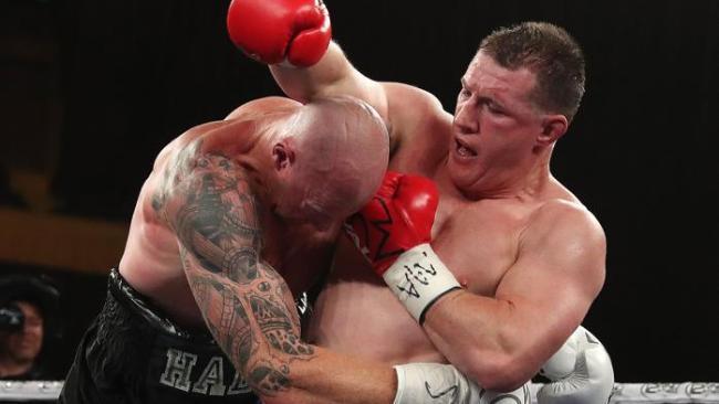 Paul Gallen tries to get an uppercut as Barry Hall hangs on to him. Picture: Michael Klein